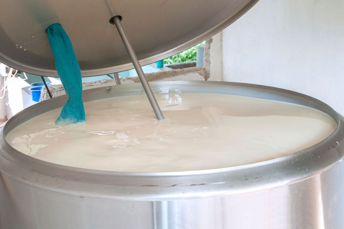 A large metal tank filled with raw milk.