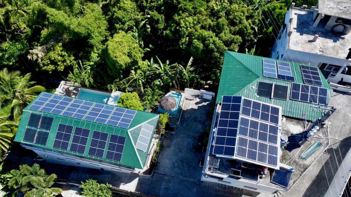 Aerial view of two buildings with solar panels.