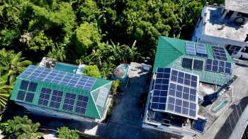 Aerial view of two buildings with solar panels.