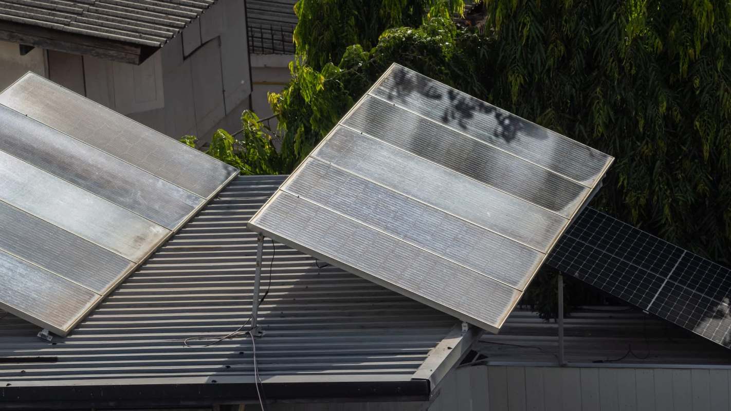 Two solar panels installed on a sloped roof.