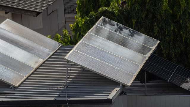 Two solar panels installed on a sloped roof.