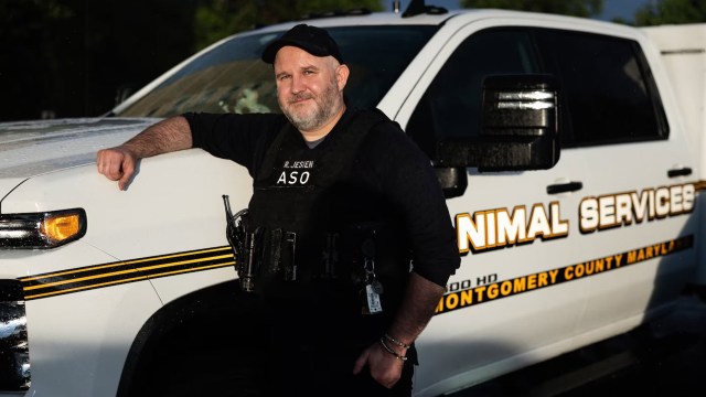 Ryan Jesien next to an animal control vehicle.