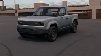 A gray pickup truck at the top of an empty parking garage.