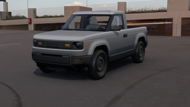 A gray pickup truck at the top of an empty parking garage.