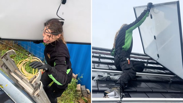A person wearing black and green clothing installs solar panels on a roof while using a ladder.