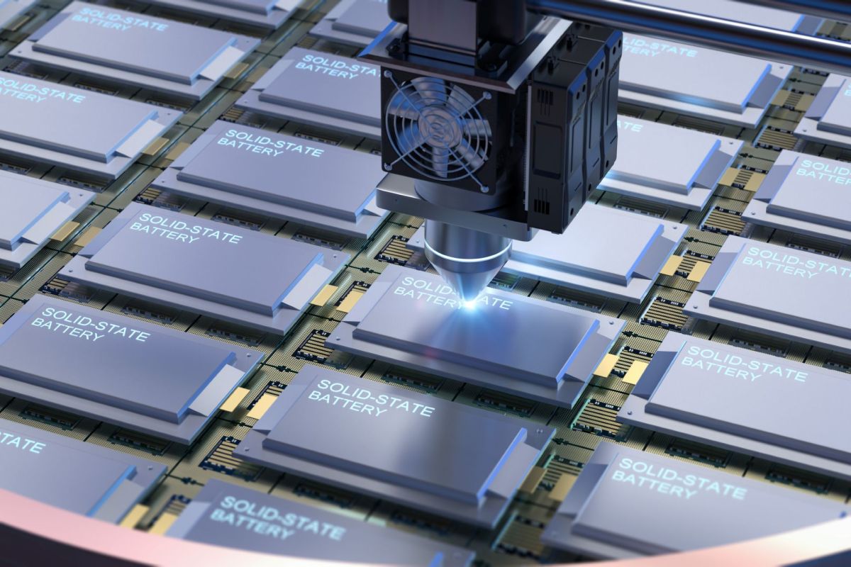 A robotic arm assembling solid-state batteries on a circuit board.