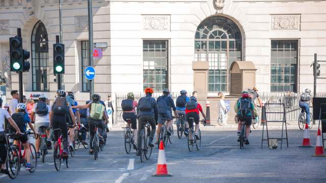 Cyclists riding through an intersection.