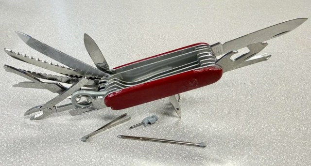 A red Swiss army knife with all its pieces opened