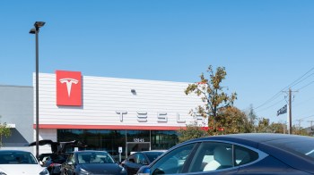 A Tesla showroom with a full outdoor lot.