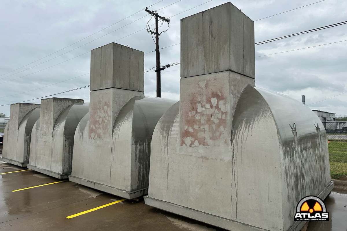 A row of concrete survival shelters.