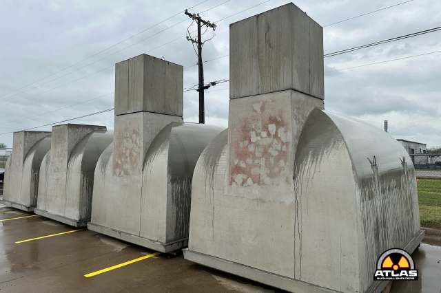 A row of concrete survival shelters.