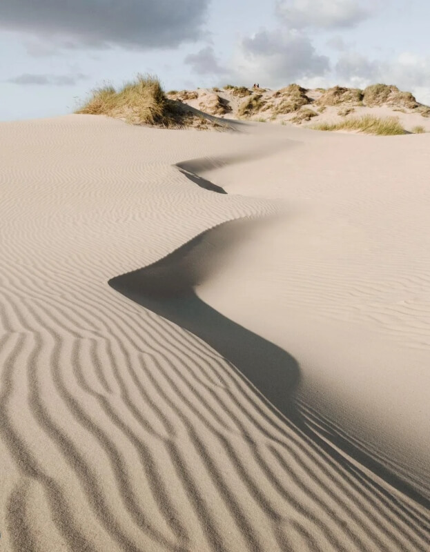 A winding sand dune on a sunny day.