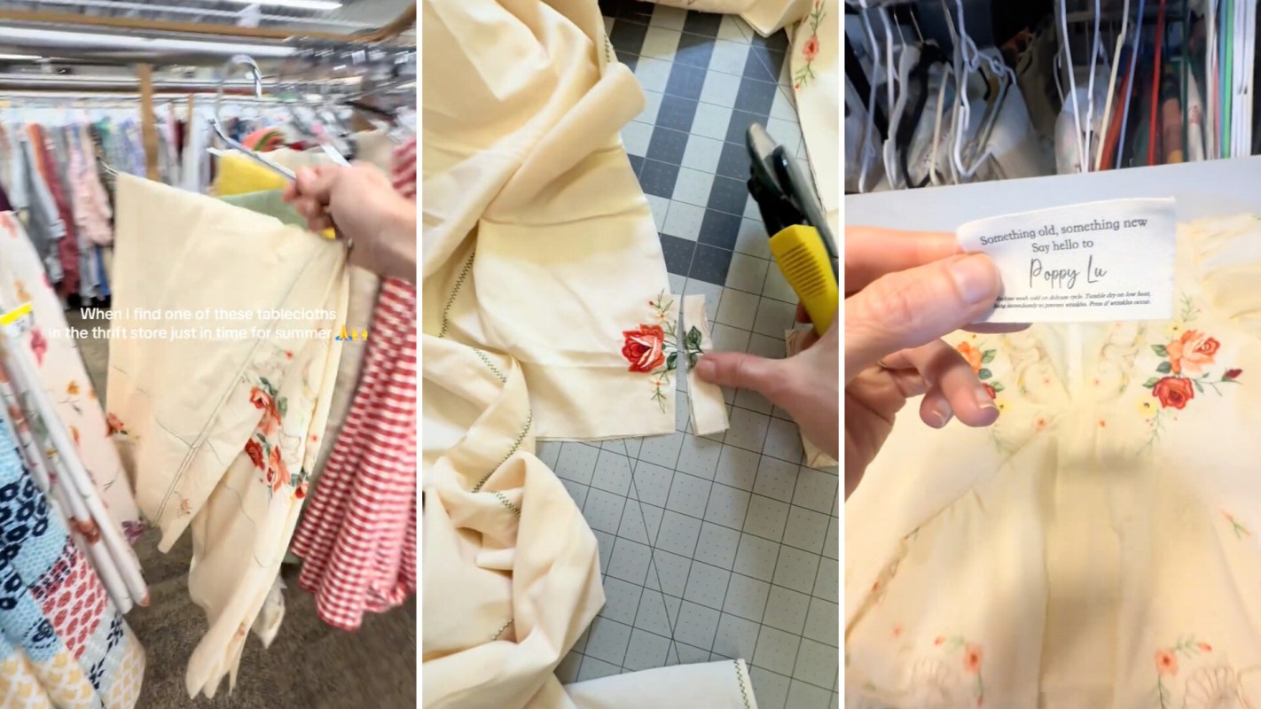 A person examines a vintage embroidered tablecloth in a thrift store, preparing to repurpose it.