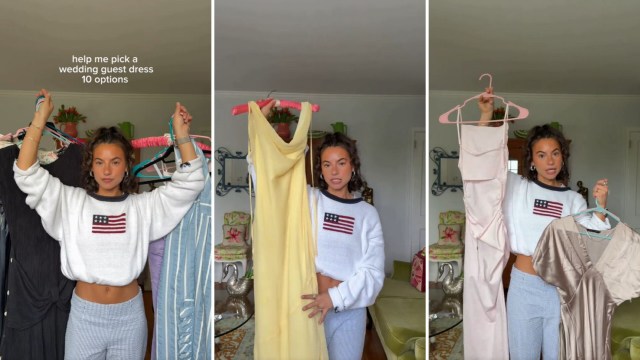 A woman holds several dress options on hangers while asking for help in choosing a wedding guest outfit.