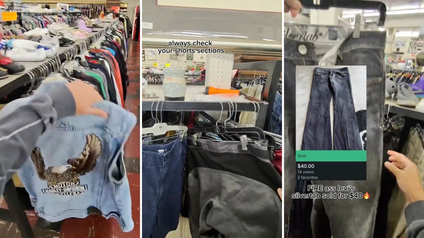 A person browsing a thrift store, holding a denim vest with an Harley-Davidson design, surrounded by various clothing items.