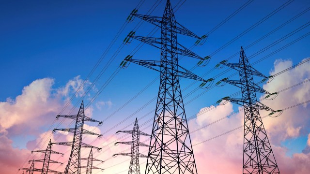 Silhouettes of high-voltage power lines.