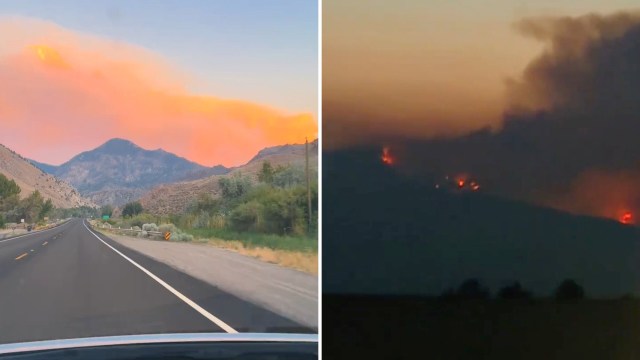 A road leading to mountains under a smoky sunset and flames on a distant hillside.