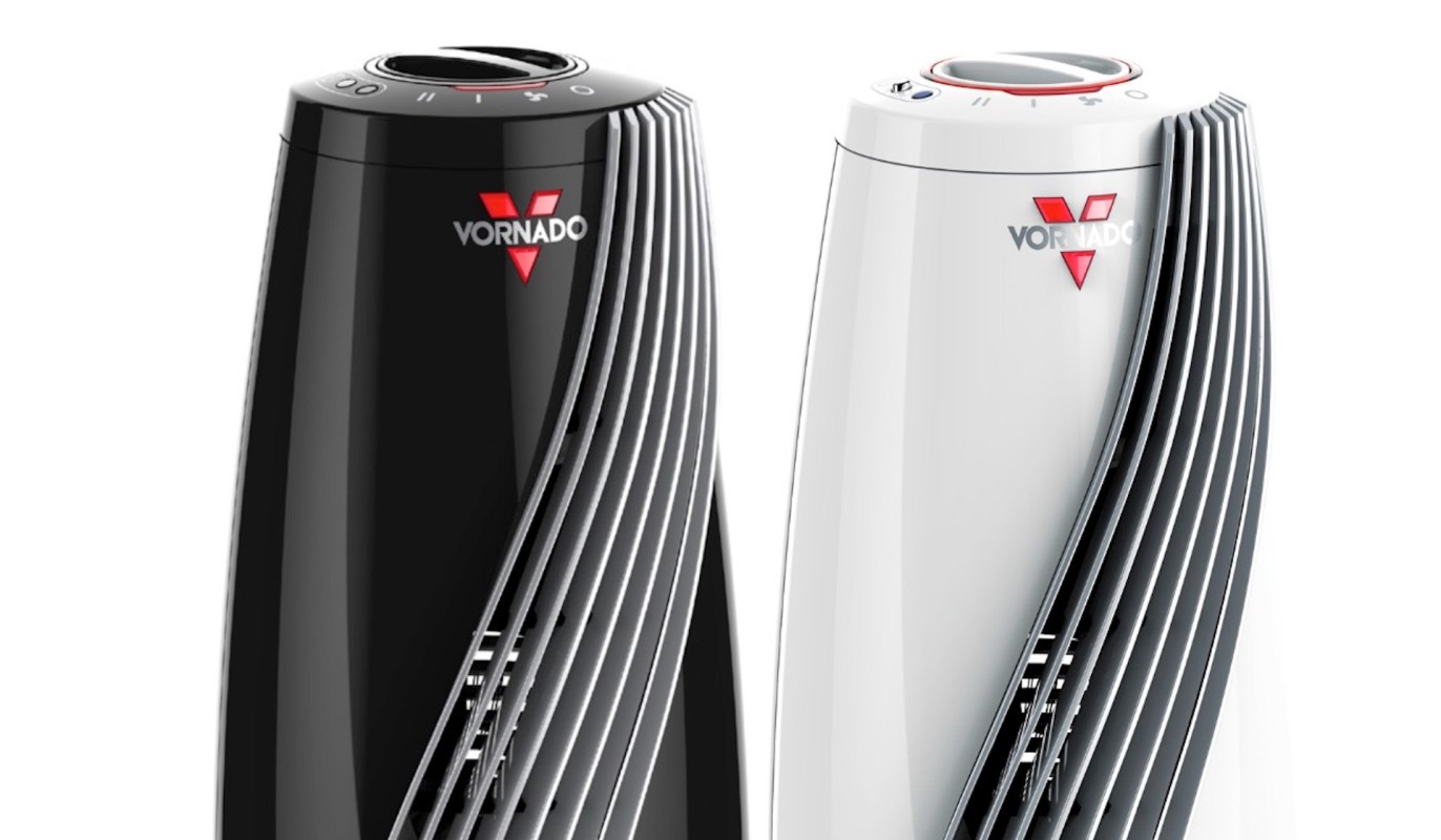 Two Vornado space heaters, one black and one white, featuring sleek designs and control knobs on top.