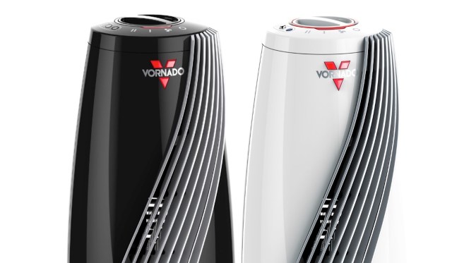 Two Vornado space heaters, one black and one white, featuring sleek designs and control knobs on top.