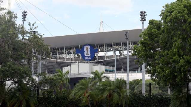 A view of a partially obscured stadium with a FIFA World Cup 2026 banner against a backdrop of greenery.