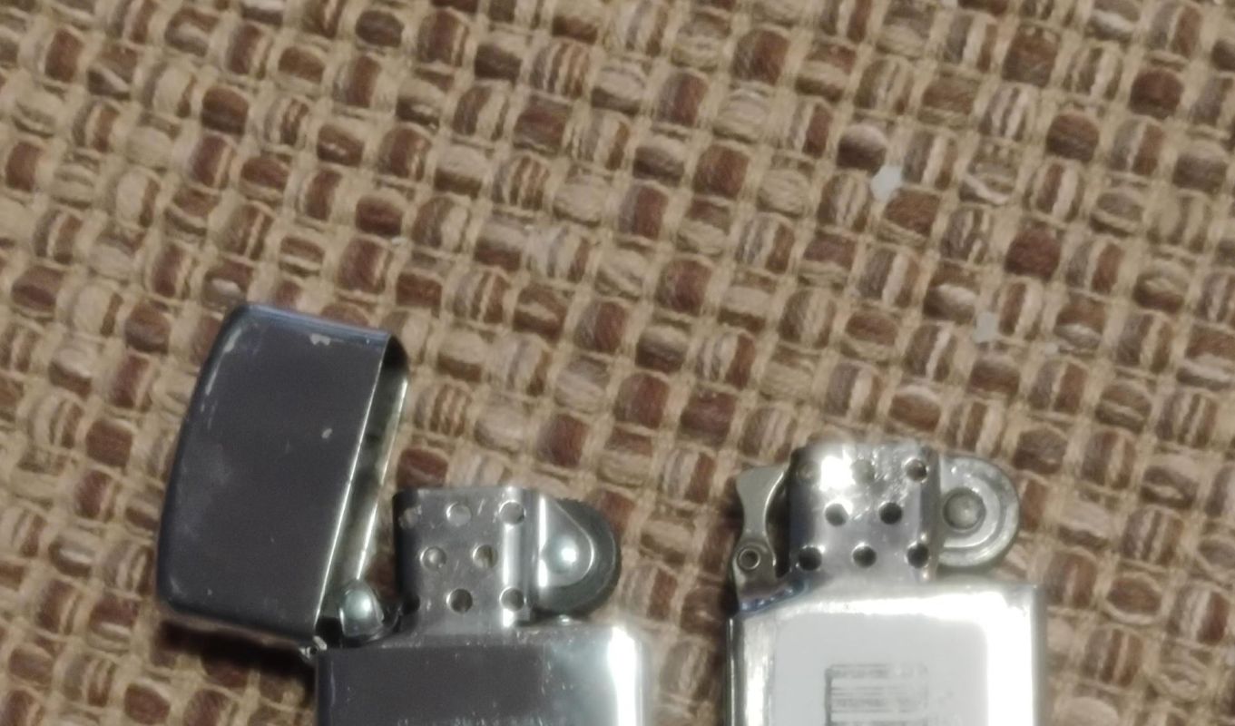 An old and a new Zippo lighter.