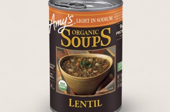 A can of Amy's Organic Lentil Soup featuring a bowl of soup on the label, highlighting its gluten-free and organic qualities.