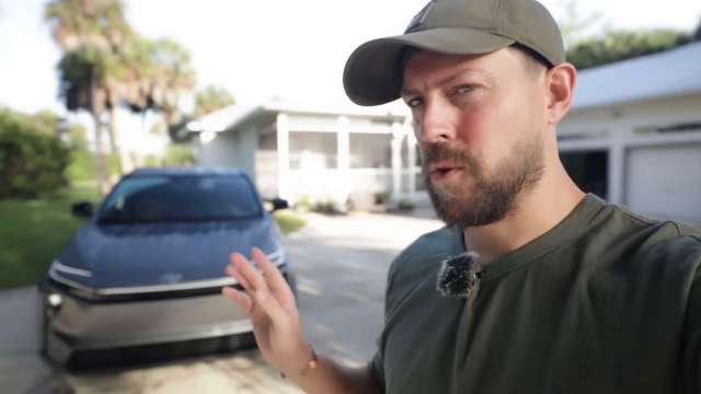 Automotive content creator Kirk Kreifels gestures toward a 2026 Toyota bZ.