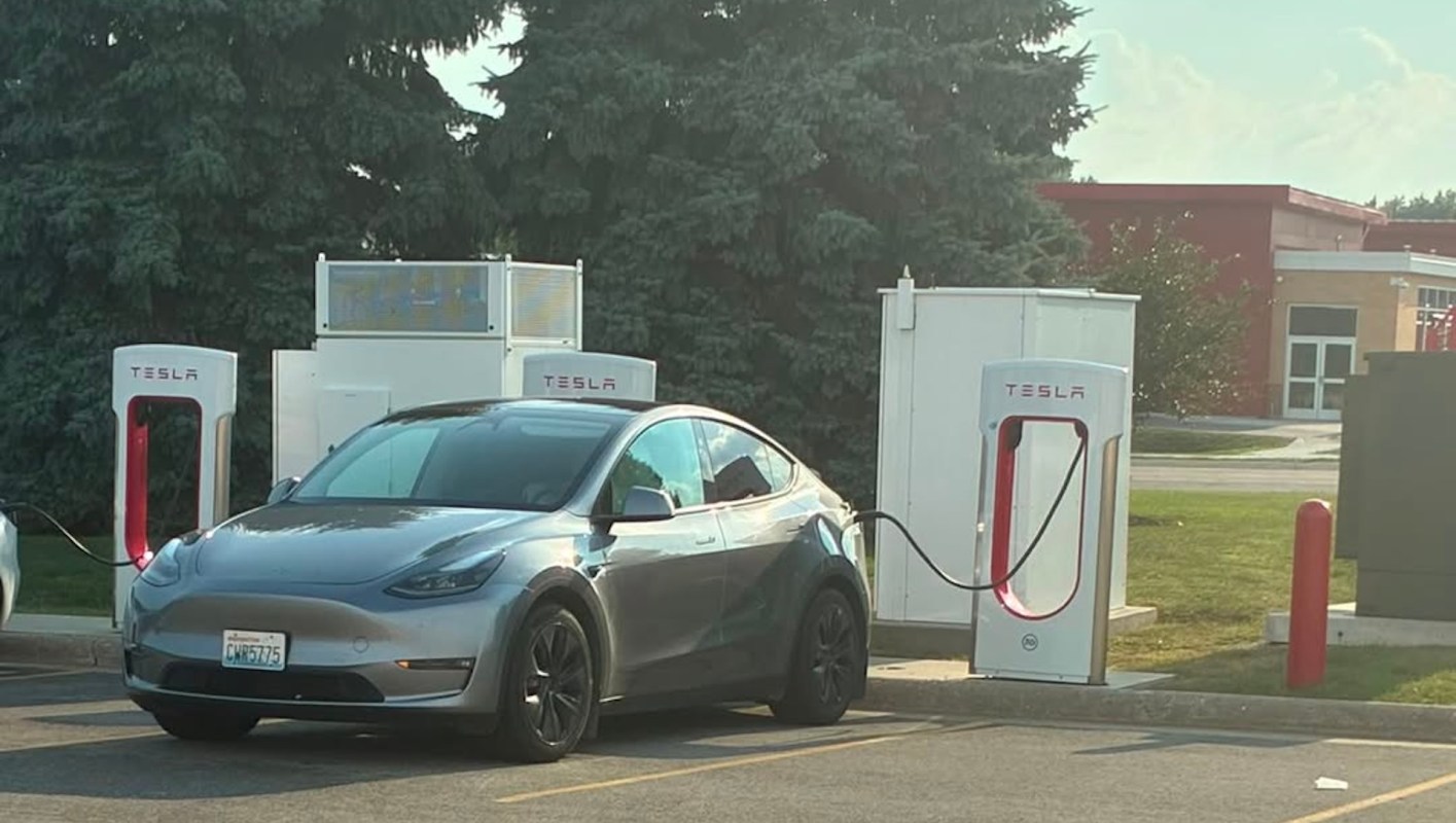 A Tesla Model Y using a Tesla Supercharger.