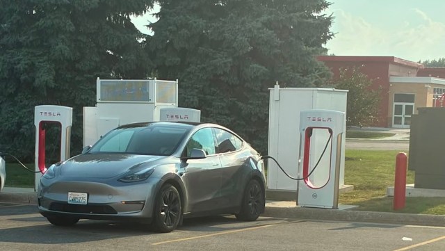 A Tesla Model Y using a Tesla Supercharger.