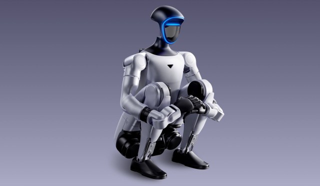 A humanoid robot with a sleek design squatting on a smooth surface against a gradient background.