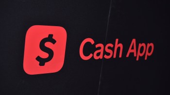 A close-up of the Cash App logo featuring a dollar sign on a black background.