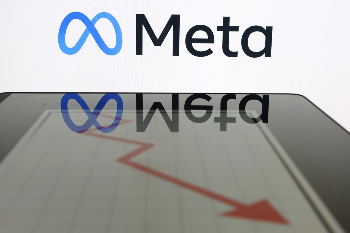 The Meta logo reflecting in a downward trending graph.