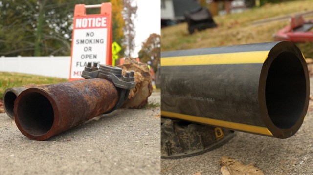 A rusty pipe and a new pipe sitting on a sidewalk.