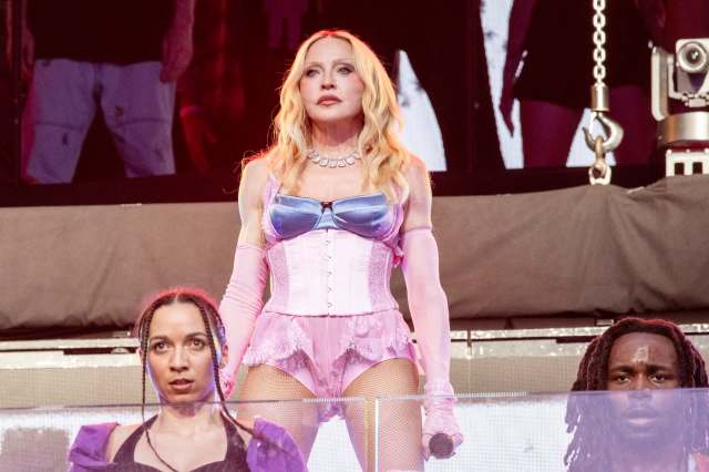 Madonna performing on stage with backup dancers.