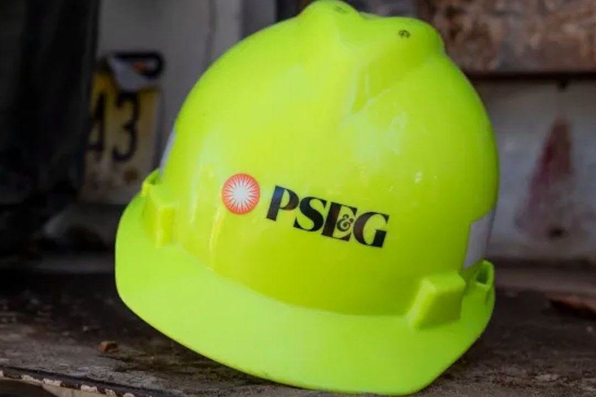 A bright yellow hard hat with the logo of PSEG displayed prominently on the front.