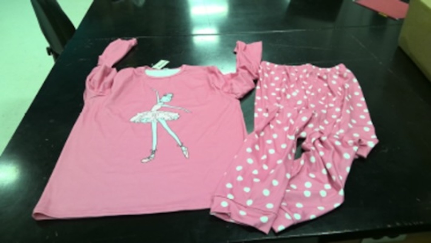 A pink shirt with a ballet dancer graphic and matching polka dot pajama pants.