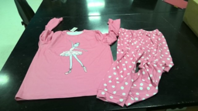 A pink shirt with a ballet dancer graphic and matching polka dot pajama pants.