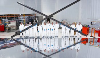 Scientists posing with reflective technology.