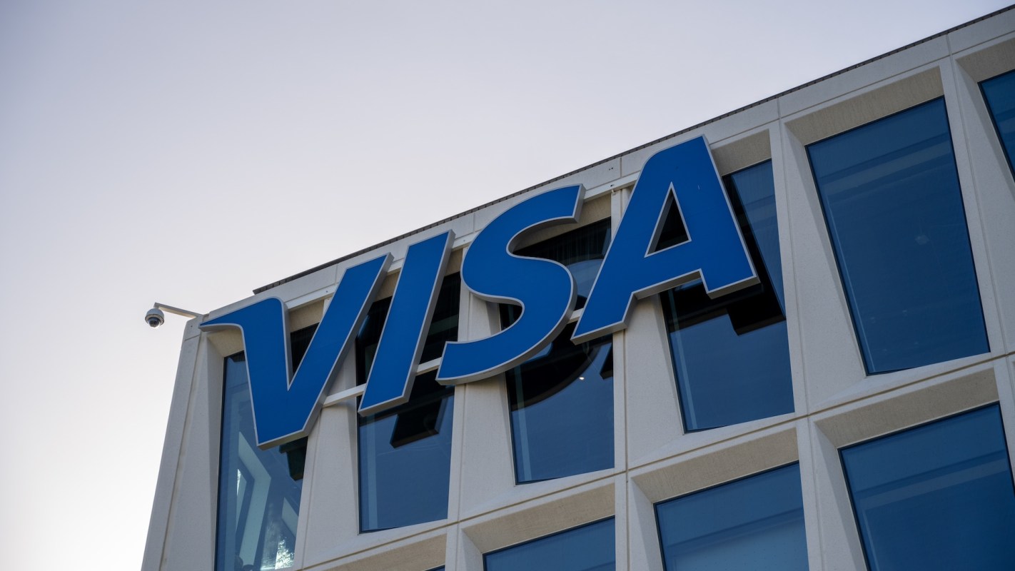 The Visa logo displayed on a modern building exterior.