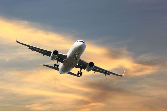 A commercial airplane ascends.