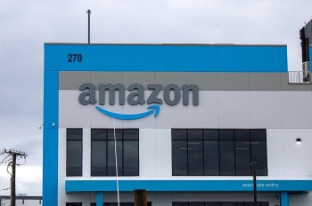 A large Amazon building featuring the company's logo and an "associate entry" sign.