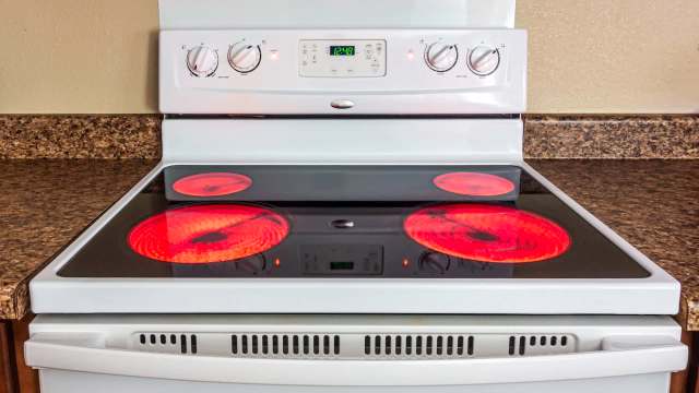 An electric stove with its burners on.