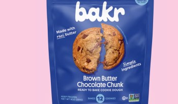 A blue packaging for bakr's Brown Butter Chocolate Chunk cookie dough with an image of a broken cookie.
