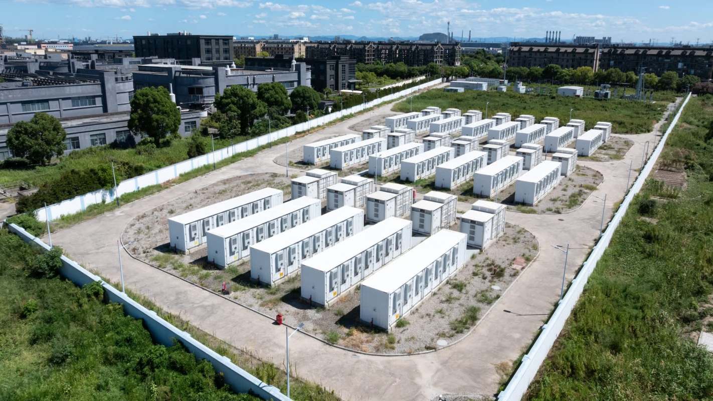 An aerial view of white battery storage units arranged in rows.