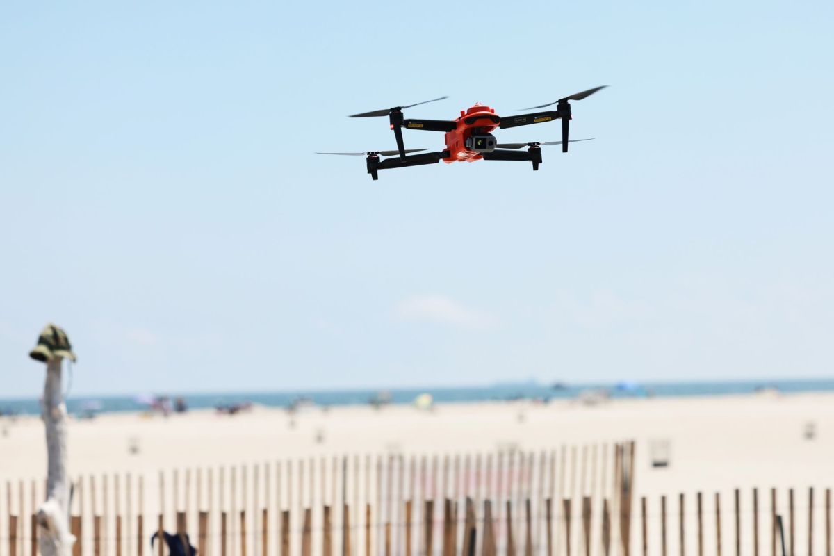 A drone flying above a beach.