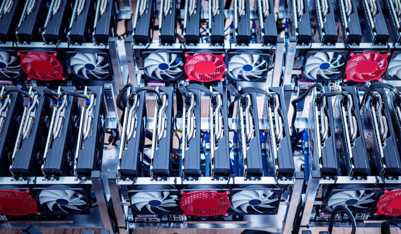 A close-up view of several graphics processing units (GPUs) arranged in a computer mining rig.