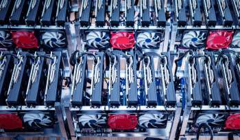 A close-up view of several graphics processing units (GPUs) arranged in a computer mining rig.