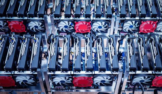 A close-up view of several graphics processing units (GPUs) arranged in a computer mining rig.