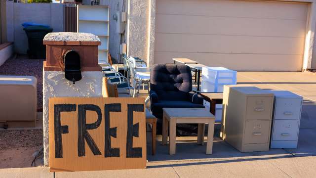A "Free" sign in front of used furniture.