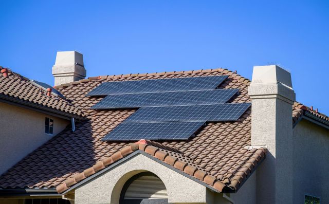 A house with rooftop solar panels.